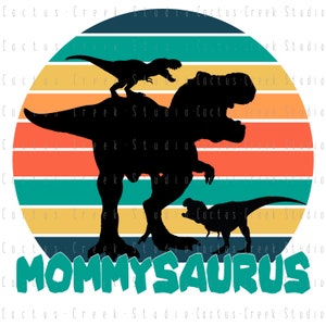May include: A retro-style illustration of a Tyrannosaurus Rex dinosaur with two smaller dinosaurs on its back. The background is a sunset with orange, yellow, red, and blue stripes. The text "MOMMYSAURUS" is written in green letters below the dinosaurs.