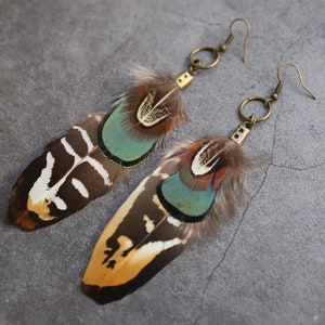 Green & golden real handmade feather earrings on stone background. Unique natural bird feathers, Boho chic hippie funmetsy bestseller, Amazira. Boho hippie feather statement, Best friend gift for her