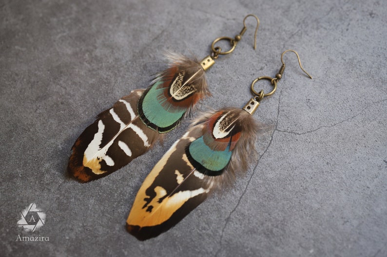 Green & golden real handmade feather earrings on stone background. Unique natural bird feathers, Boho chic hippie funmetsy bestseller, Amazira. Boho hippie feather statement, Best friend gift for her