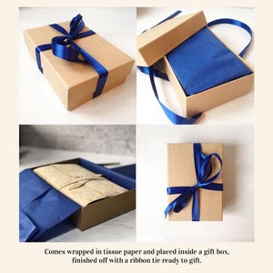 May include: A collection of images showcasing a gift box. The box is a natural brown color and tied with a vibrant blue ribbon. Inside, the gift is wrapped in blue tissue paper. The text in the image says, "Comes wrapped in tissue paper and placed inside a gift box, finished off with a ribbon tie ready to gift."