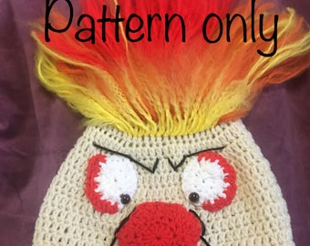 May include: Crochet pattern for a red-nosed, angry-faced character with yellow and orange hair. The pattern is called "Pattern only".