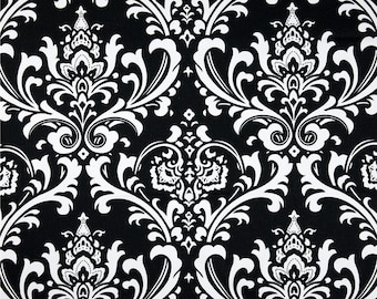 May include: Black and white damask fabric with a repeating pattern of intricate floral designs. The fabric has a smooth, silky texture.