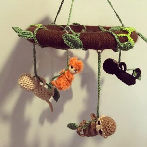 Round crochet monkey baby cot mobile.