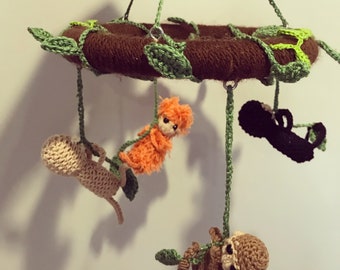 Round crochet monkey baby cot mobile.