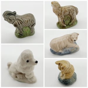 May include: A collection of five ceramic figurines, including an elephant, a wolf, a polar bear, a poodle, and a dog. The figurines are all hand-painted and have a vintage look.