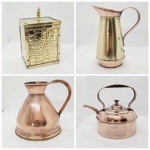 May include: A set of four antique copper and brass kitchenware items. The set includes a copper kettle, a copper jug, a brass jug, and a brass box with a crocodile skin pattern.