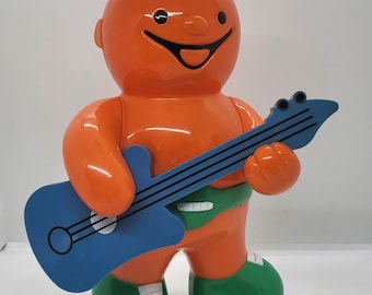 Jelly baby Money Box, piggy bank, orange Jelly baby Bumper playing the guitar, Bertie Bassets advertising vintage collectible, replacement