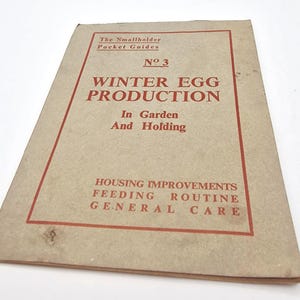 May include: A vintage booklet titled "Winter Egg Production" from "The Smallholder Pocket Guides." The cover is tan with red text and a red border. The booklet covers topics like housing improvements, feeding, routine, and general care.