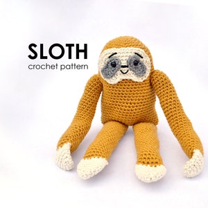 May include: A handmade crochet sloth toy in shades of mustard yellow, gray, and cream. The sloth has long arms and legs, with cream-colored paws. The text "SLOTH crochet pattern" is displayed above the sloth.