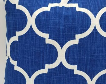 May include: Blue and white geometric patterned throw pillow. The pillow has a white trellis pattern on a blue background.
