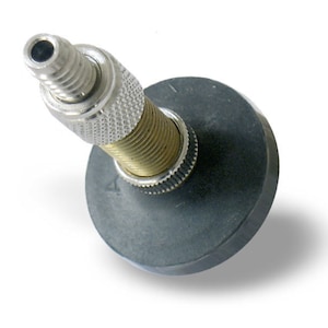 May include: A silver and brass bottle stopper with a black rubber base. The stopper has a threaded design and a small hole at the top.