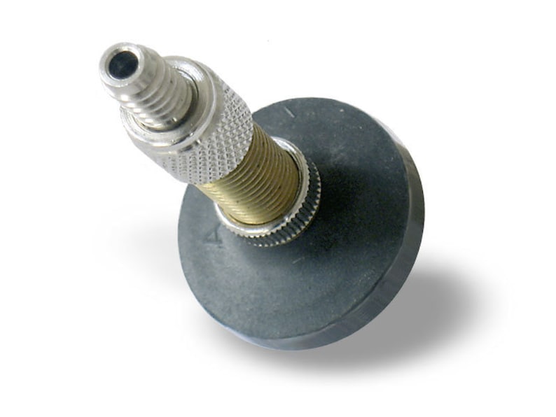 May include: A silver and brass bottle stopper with a black rubber base. The stopper has a threaded design and a small hole at the top.