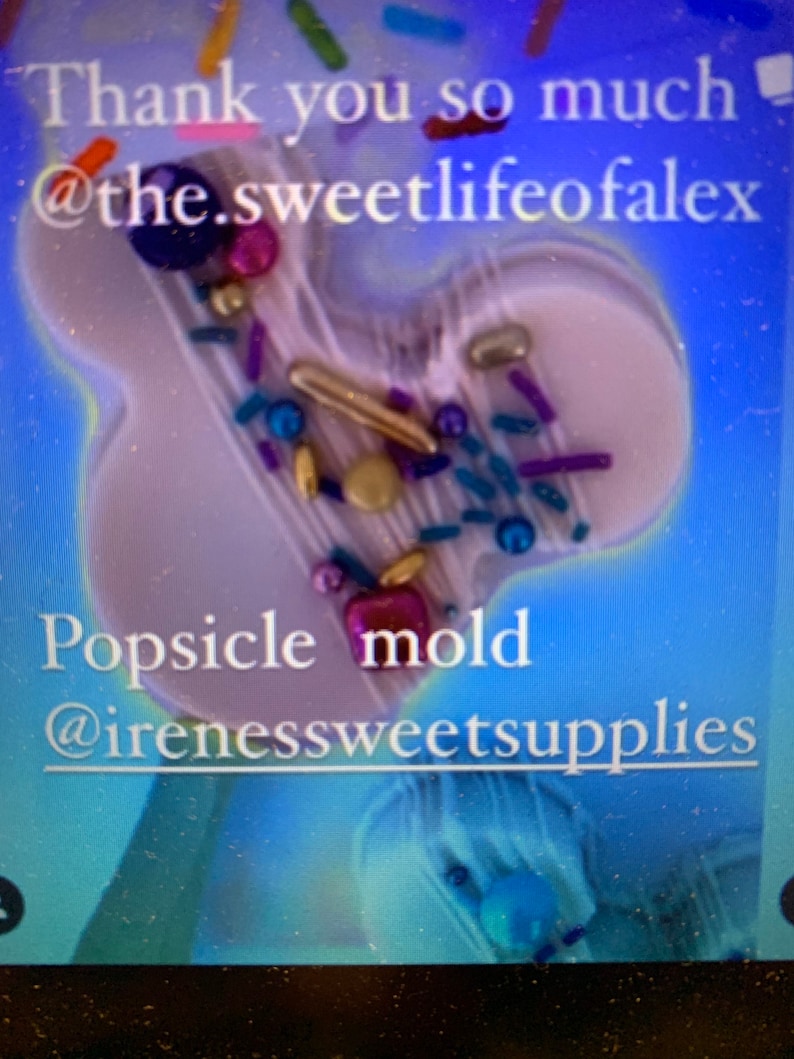 May include: A light purple, mouse-shaped silicone popsicle mould decorated with various colourful sprinkles, including gold, blue, and purple beads and rods. The text reads: Thank you so much @the.sweetlifeofalex Popsicle mould @irenessweetsupplies.