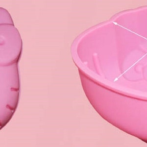 May include: Pink silicone Hello Kitty-shaped baking mold with measurements: 6.06 inches wide, 5.35 inches long, and 3.0 inches deep.