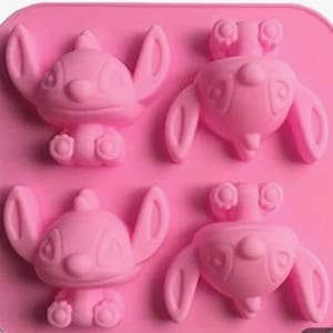 May include: A pink silicone mould featuring four Stitch character designs. The mould has a rectangular shape with detailed impressions of the cartoon character, ideal for making themed treats or crafts.