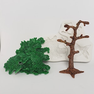 May include: A green, textured tree and a brown tree figurine are displayed. A white silicone mold with tree and star shapes is also visible. The objects are set against a white background.