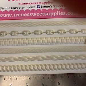 May include: A white silicone mould with five different designs for making cake decorations. The designs include a chain link, a woven pattern, a rope, and two different braided patterns. The mould is measured with a ruler in inches.