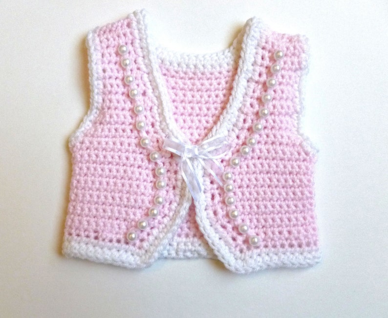 pink and white sweater vest