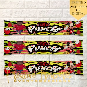 May include: Three colorful candy bar wrappers with a yellow background, red and black polka dots, and a lightning bolt design. The wrappers feature a cartoon image of Mickey Mouse, a child, and the text "DJ's Punchy Sour Straws".
