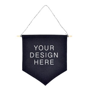 May include: Black canvas banner with wooden dowels and white string hanging from the top. The banner has the text "YOUR DESIGN HERE" printed in white.