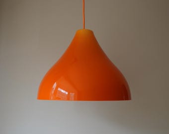 May include: Orange pendant light with a rounded, bell-shaped shade.