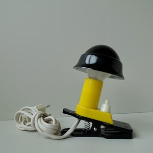New old stock in box vintage 1970s QUWI yellow and black aluminium and bakelite German design clip on bedside desk lamp book reading light