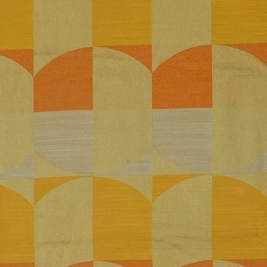 May include: A repeating pattern of geometric shapes in shades of yellow, orange, and beige. The pattern is made up of half circles and squares.