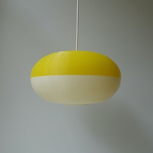 Very pretty yellow white bi-color oval shaped light-weight Rotaflex corrugated spaghetti spiral pendant light lamp mid century modern 1970s