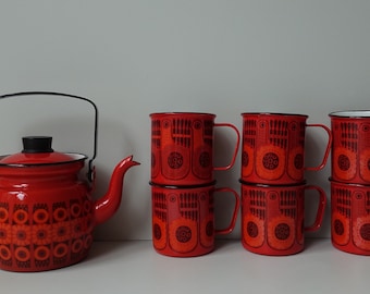 May include: A set of red enamel mugs and a matching teapot with black and orange geometric designs. The mugs have white interiors and black rims.