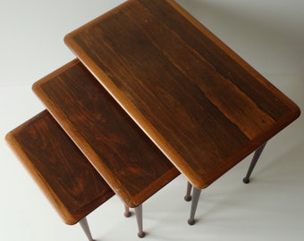 Complete set of three hard exotic rosewood wooden 1960s nesting side tables stackable mid century modern tapered legs