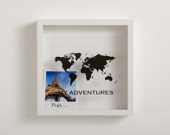 May include: White shadow box with a black world map and a photo of the Eiffel Tower in Paris. The photo has the text "Paris" and "My Adventures" written on it.