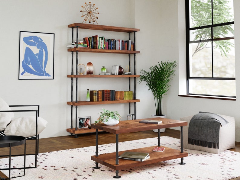 May include: A rustic wooden bookshelf with black metal pipes, featuring five shelves filled with books, decorative items, and plants. The bookshelf is in a living room setting with a coffee table, a rug, and a window.