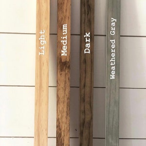 May include: Four wood samples showing different stain colors: light, medium, dark, and weathered gray.