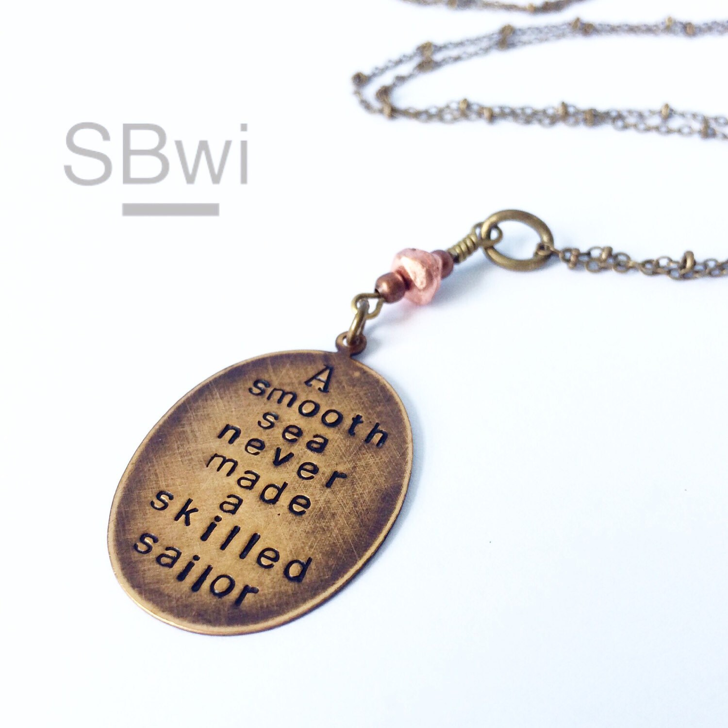 A Smooth Sea Never Made a Skillful Sailor Necklace in Bronze. Word