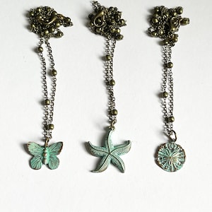 Choose a necklace: butterfly, sand-dollar, or starfish. Bronze necklace. virdigis pendant. Green necklace. Satellite necklace.
