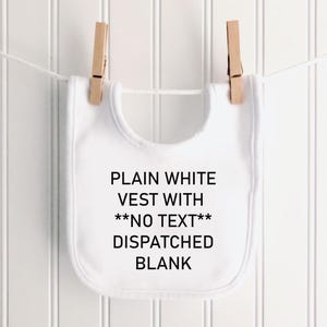 May include: A plain white baby bib hanging from a white string by two wooden clothespins. The bib features black printed text that reads: PLAIN WHITE VEST WITH **NO TEXT** DISPATCHED BLANK. The bib has a rounded shape and a smooth fabric texture.