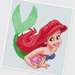 May include: A red-haired mermaid with a green tail holds a pink and blue book that says "Fish & Chips" in white letters.