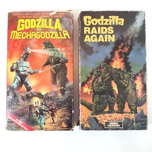 Godzilla VHS Lot of 2 - Godzilla vs. Mechagodzilla - Godzilla Raids Again (Gigantis, The Fire Monster) - Tested and Working - New World