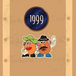 May include: A brown door with a blue circle containing the number 1999.  Two Mr. and Mrs. Potato Head characters are on the door.  The text "Laminated CardStock" is at the bottom of the door.