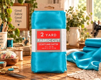 May include: A folded piece of bright turquoise costume satin fabric wrapped in a paper band labeled 2 YARD FABRIC CUT COSTUME SATIN 72 x 58 IN 182.9 x 147.3 CM. The fabric has a smooth, shiny finish and is presented as a rectangular bundle.