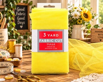 May include: A folded piece of bright yellow tulle fabric wrapped in a white paper band with a red label that reads 3 YARD FABRIC CUT TULLE 108x54 IN 274.3x137.2 CM. The fabric is translucent and has a fine mesh texture, displayed as a single unit.
