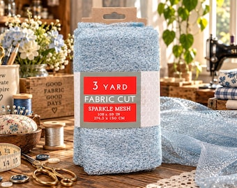 May include: A folded piece of light blue sparkle mesh fabric with a paper label that reads 3 YARD FABRIC CUT SPARKLE MESH 108 x 59 IN 274.3 x 150 CM. The mesh has a glittery texture and is displayed as a rectangular bundle on a wooden surface.