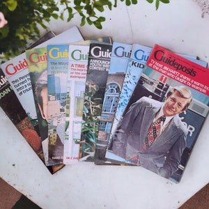 May include: A stack of vintage magazines with the title "Guideposts" on the top magazine. The magazine cover features a man in a suit and tie. The other magazines have titles like "Guide", "The Mayday", "A Time to Heal", and "Announcing Youth Contest Winners".