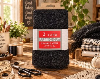 May include: A roll of black sparkle mesh fabric with a paper label reading 3 YARD FABRIC CUT SPARKLE MESH 108 x 59 IN. The mesh has a glittery texture and is wrapped in a rectangular band. The fabric is displayed on a wooden surface with sewing tools.