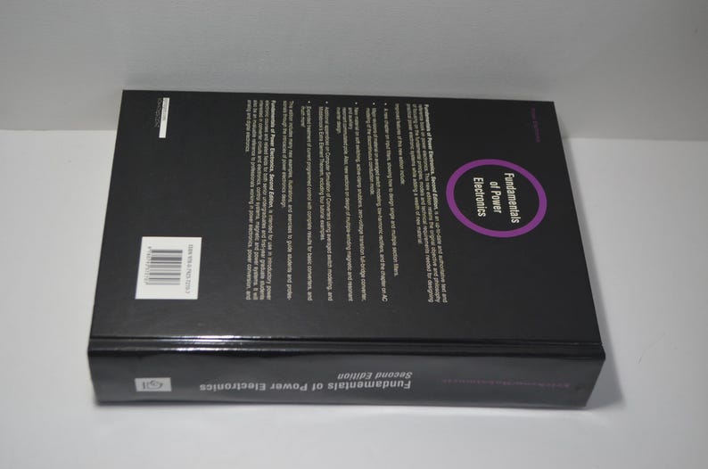 May include: The back cover of a black book titled "Fundamentals of Power Electronics" with the second edition printed on the bottom. The book has a purple circle with the text "Fundamentals of Power Electronics" inside.