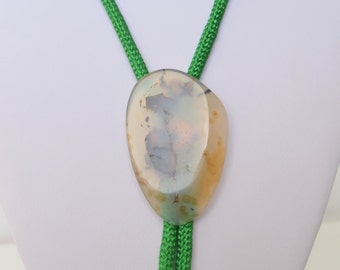 May include: A green bolo tie with a light brown, white, and gray agate stone pendant.