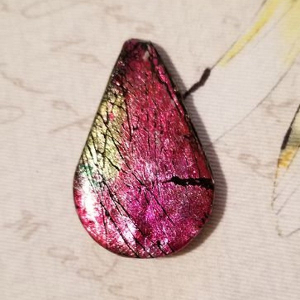 Faux Ammolite pendant in red, gold, and black. Stamped gold back, glaze finish, 2" long