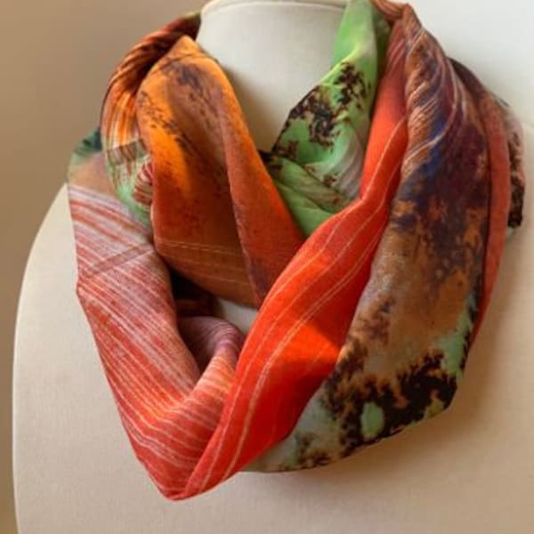 Silk chiffon infinity scarf, 54" x 6.5. Green, brown, pink, purple in an abstract pattern.