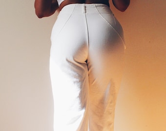 May include: White high-waisted pants with a straight leg fit.
