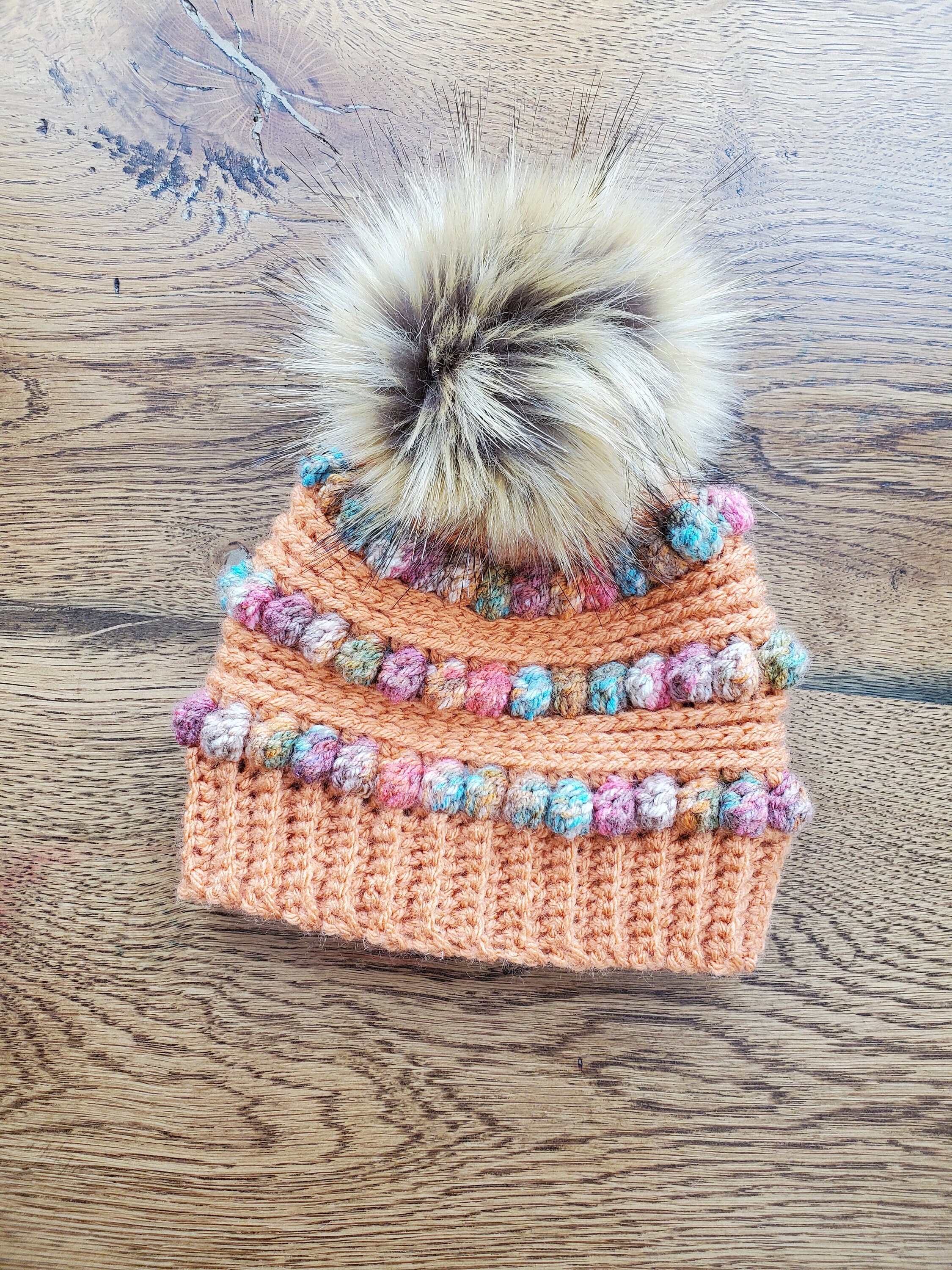 Baby crochet hatfaux fur pom pomorange with jewel tones9-12 months